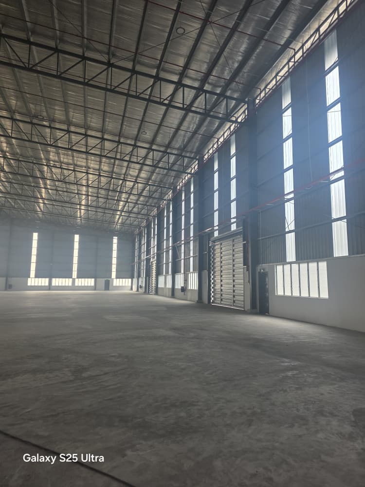 Spacious factory floor with high steel roof